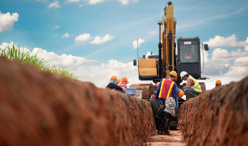 construction crew digging a ditch